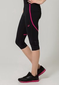 Black athletic capris with pink side stripes and logo, featuring a fitted design and textured finish, ending below the knee.