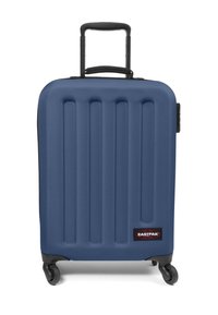 Blue hard-shell suitcase with vertical ridges, black accents, retractable handle, and four wheels for mobility. Brand logo on front.