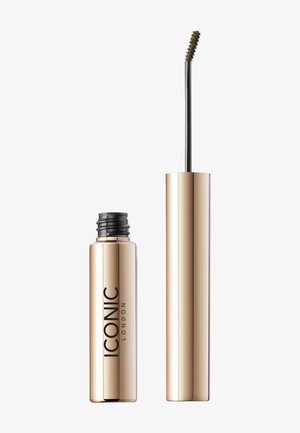 Tube de mascara cylindrique doré avec un logo noir bien visible, accompagné d'une baguette fine avec une brosse à poils incurvés.