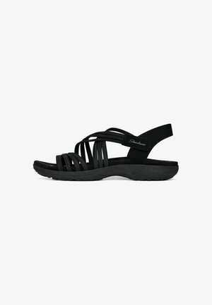 Sandalia negra de mujer Skechers con múltiples tiras elásticas y una suela acolchada, con una tira trasera con cierre de velcro.