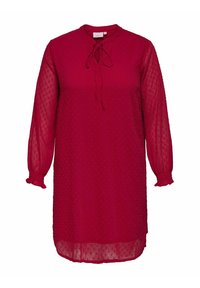 Czerwona sukienka z przezroczystego materiału z wzorem w kropki, okrągły dekolt, wiązania, długie bufiaste rękawy z elastycznymi mankietami oraz luźny krój.