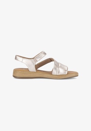 Women's metallic beige sandal with two adjustable straps and a low wooden wedge heel, side view on white background.