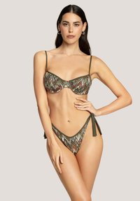 Set di bikini in tessuto stampato con colori verde, rosso e crema. Il top presenta stecche e spalline regolabili; il fondo include lacci laterali.
