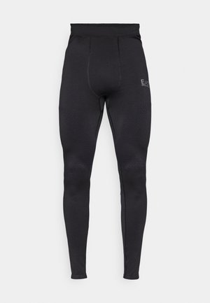 Leggings noirs actifs avec un motif de panneaux texturés, taille haute et coupe ajustée. Présente un logo discret sur la cuisse supérieure.
