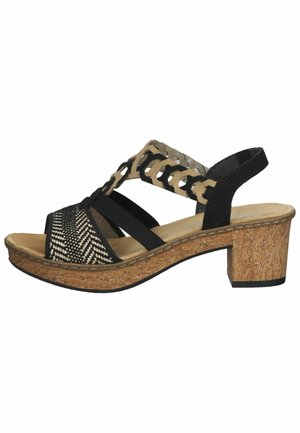 Sandale noire et beige à bout ouvert avec bride avant tissée, bride de cheville décorative ajourée, talon bloc en liège et bride arrière de maintien.