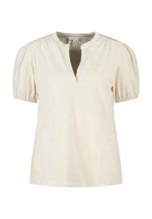 Blouse à manches courtes couleur crème, coupe ample, manches bouffantes froncées et col en V fendu.