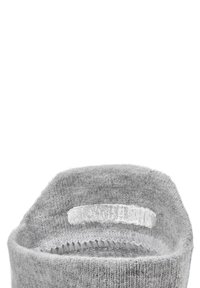 Gray knitted sock with a textured finish, featuring a transparent non-slip grip band on the inner cuff for added stability.