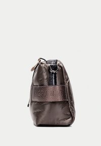 Sac matelassé marron avec une bande noire glossy et une texture embossée, doté d'une fermeture à cordon et d'un accent matériel circulaire.