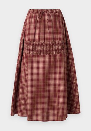 Red plaid skirt with an elastic waistband and adjustable tie. Features a smocked section, lightweight fabric, and a flared silhouette.