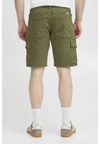 Bermudas de cargo en verde oliva con un corte relajado, que cuentan con varios bolsillos, una cinturilla elástica y un corte a la altura de la rodilla.