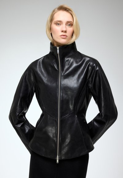 Black leather jacket with a high collar, zip front, and tailored fit. Features smooth texture and seam detailing for a structured look.