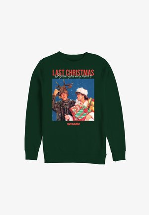 Zielony sweter z grafiką świąteczną przedstawiającą dwie postacie otoczone śniegiem. Tekst brzmi: „W zeszłe Boże Narodzenie dałem ci swoje serce.”