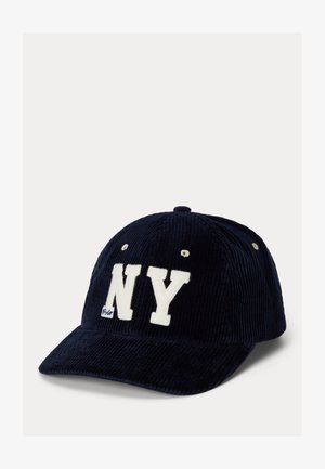 Navy blue corduroy cap with white "NY" lettering and soft texture. Features button and eyelet details on the top for ventilation.