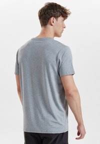 Gray short-sleeve t-shirt made of cotton blend fabric. Relaxed fit with crew neckline and smooth texture. No visible patterns or accents.