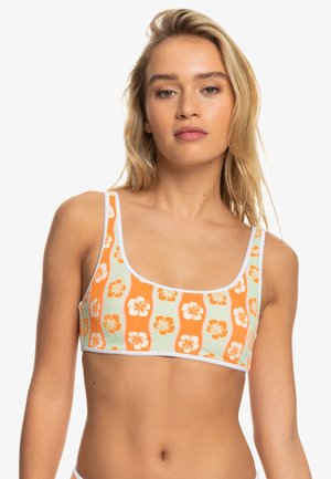 Oranje en groene geribde bikini top met witte accenten, met een bloemenpatroon van hibiscusbloemen. Scoop halslijn en brede banden.