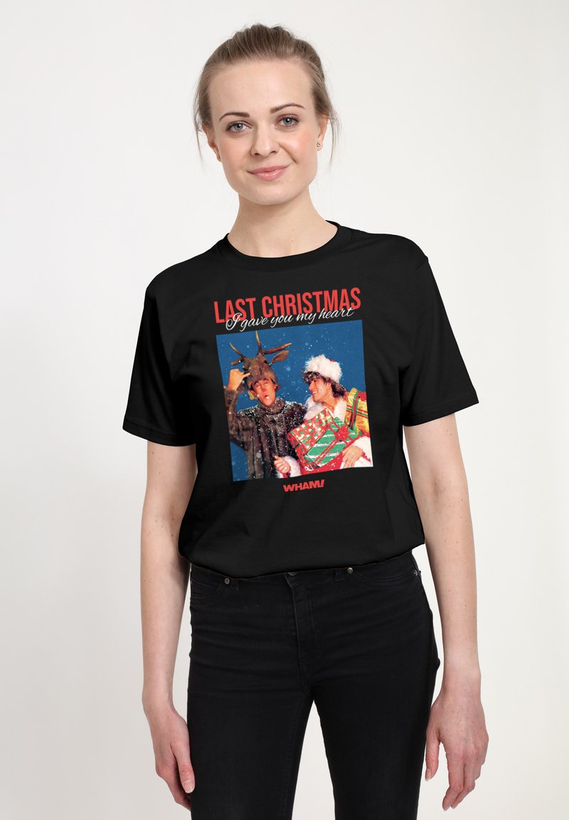 Černé bavlněné tričko s barevným grafikem zobrazujícím dva slavnostní postavy, nad obrázkem červený nápis "LAST CHRISTMAS".