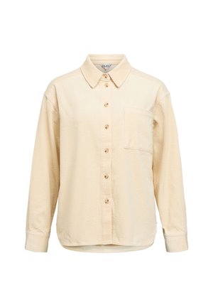 Långärmad skjorta med knappar i ljus beige corduroy, med krage, en bröstficka och räfflad struktur. Knappar i trä.