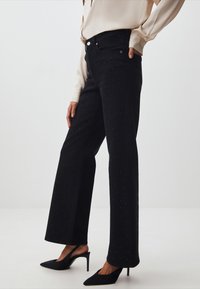 Jimmy Key WIDE LEG SHINY STONES - Jeans a zampa - black