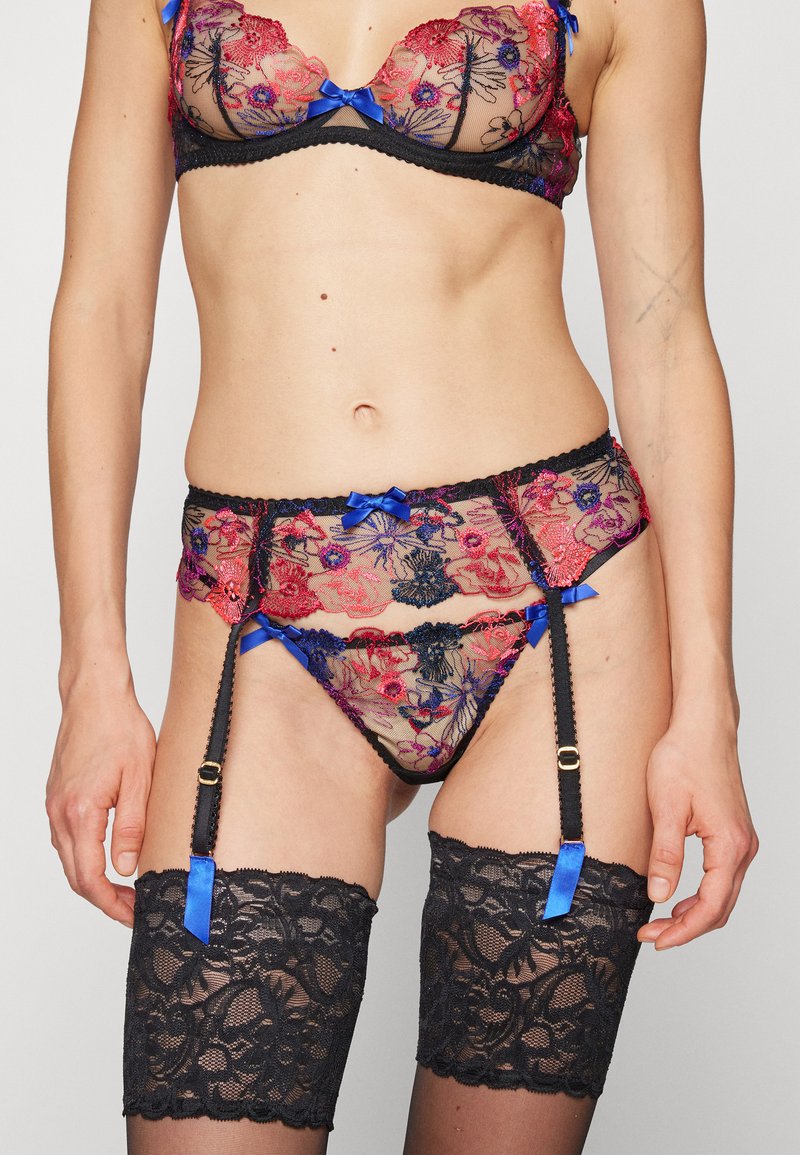 Lace lingerie set in black, red, and blue with floral designs. Features bows, scalloped edges, and garter straps attached to lace stockings.