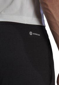 Zwarte sportshorts met AEROREADY-logo, met een gladde textuur, een zijzak met rits en een aansluitend ontwerp.