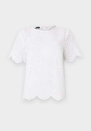 Blouse en coton blanc avec broderie ajourée, ourlet festonné et manches courtes. Motif texturé de formes circulaires et en feuilles.