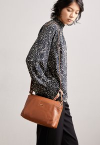 LEATHER - Cross body bag - cognac