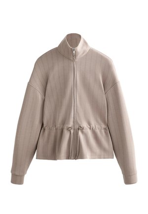 Beige jas met rits en hoge kraag, lange mouwen, verticale streepjessstructuur en verstelbaar trekkoord in de taille.