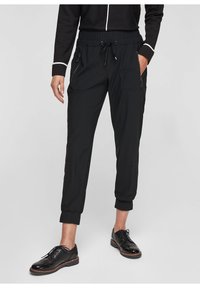 Black jogger pants with elastic waistband and adjustable drawstring, featuring two front zip pockets and tapered cuffs. Smooth fabric texture.