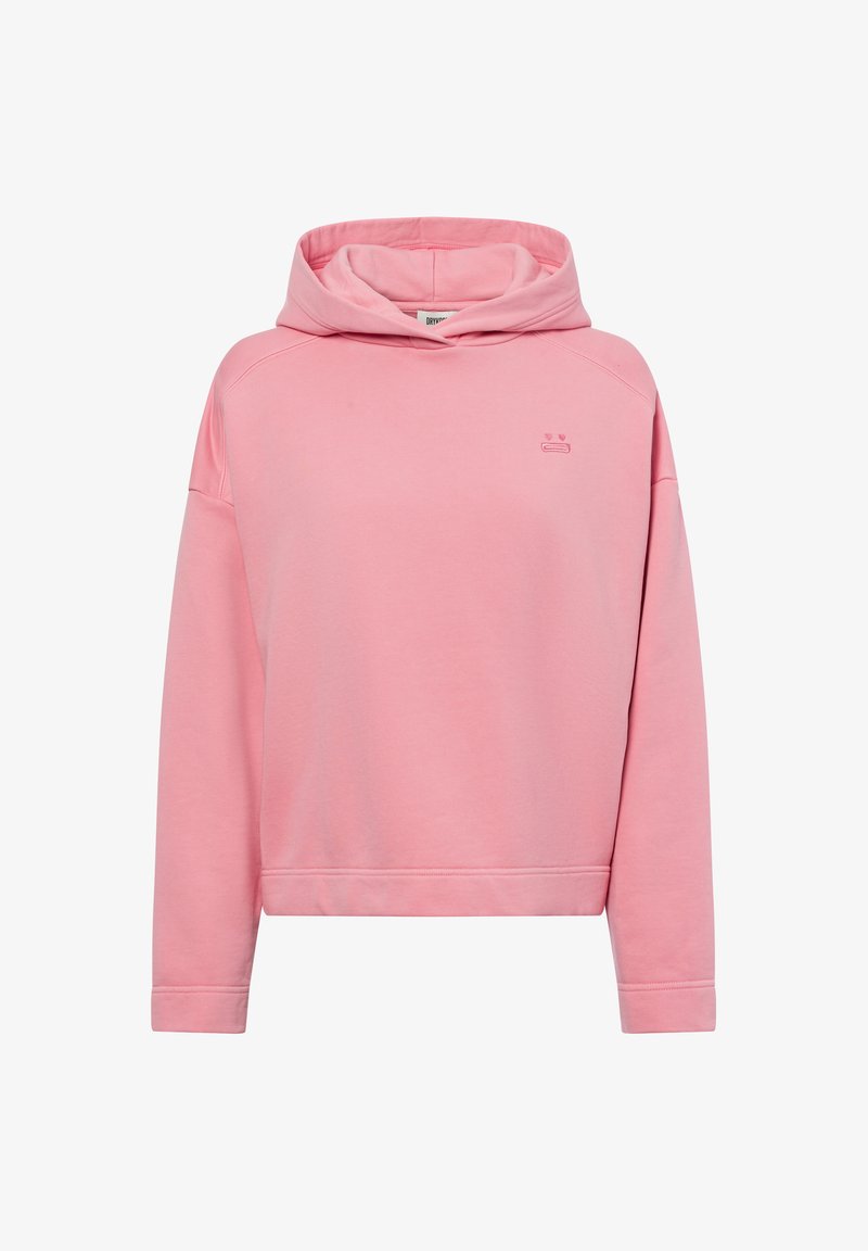 Rosa langärmeliger Kapuzenpullover mit überschnittenen Schultern und kleinem gesticktem traurigen Gesicht-Logo auf der Brust, vor einem weißen Hintergrund präsentiert.