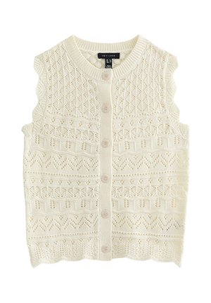 Cárdigan de punto sin mangas color crema con bordes festoneados, patrones calados intrincados y seis botones delanteros.