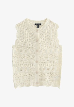 Cardigan tricoté sans manches couleur crème avec bords festonnés, motifs ajourés complexes et six boutons sur le devant.