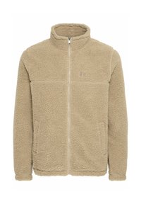 Chaqueta de forro polar beige con cierre frontal, cuello alto, dos bolsillos frontales y un logo sutil en el pecho. Superficie suave y texturada.
