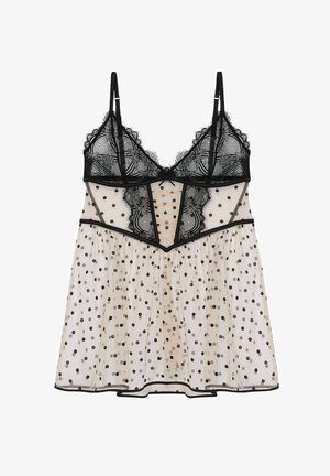 Robe cami en tissu nude transparent ornée de motifs à pois avec un ourlet en dentelle noire. Elle dispose de fines bretelles et d'une jupe fluide. Texture lisse sur l'ensemble.