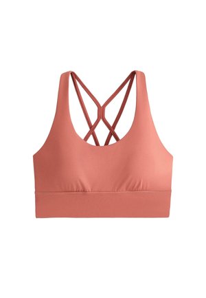 Koralowy sportowy biustonosz z cienkimi, krzyżującymi się ramiączkami na plecach oraz szerokim, podtrzymującym pasem pod biustem.