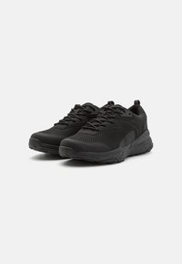 Black athletic shoes with a mesh upper for breathability, cushioned sole, textured accents, and sturdy laces for secure fit.