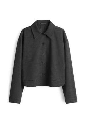 Cropped black jacket with a textured pattern, pointed collar, button front, and two front pockets. Long sleeves with a relaxed fit.