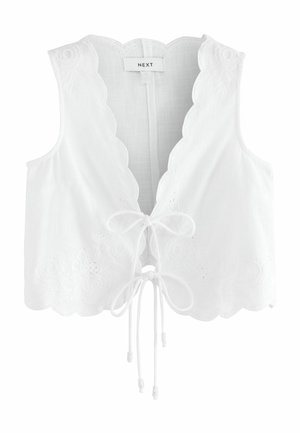 Haut court sans manches blanc avec bords ondulés, broderie florale et fermeture à nouer à l'avant, étiquette "NEXT" à l'intérieur du col.