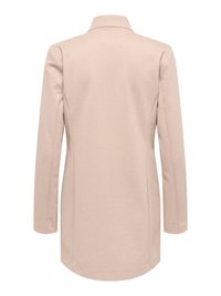 Blazer rose pâle à manches longues avec col, coupe ajustée et texture lisse ; comprend des coutures latérales et un ourlet arrondi.