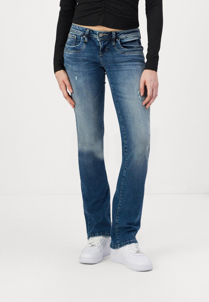 Blue denim jeans with a straight fit, featuring fading, distressed detailing, five pockets, and a button and zipper closure.