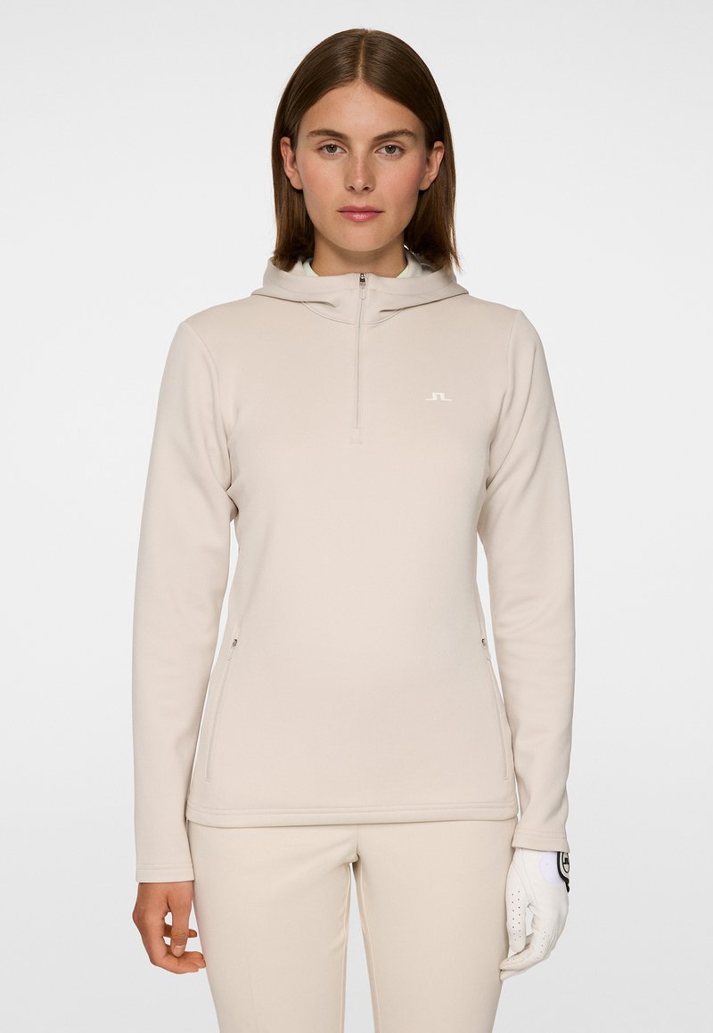 Felpa cappuccio zip beige chiaro con una texture morbida, dotata di zip frontale, cappuccio e logo discreto sul petto. Design slim fit.