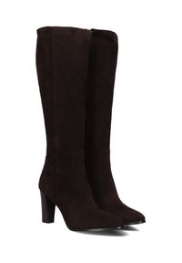 Een paar donkerbruine suède kniehoge laarzen met puntige neuzen en blokhakken, weergegeven op een witte achtergrond.