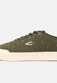 Grüne Netzsneaker mit beiger Gummisohle. Hervorgehoben durch eine abgerundete Zehenpartie, Schnürung vorne und ein Logodetail an der Seite. Strapazierfähiger, strukturierter Stoff.