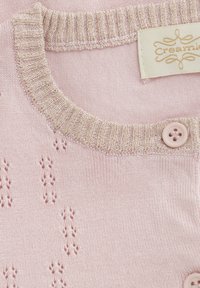 Ljusrosa stickad tröja med en texturerad, metallisk ribbad krage och dekorativ knappdetaljering. Har små broderade mönster.