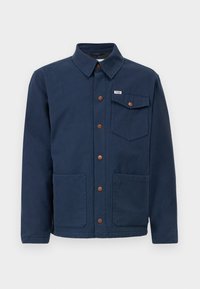Navy blue cotton jacket with a collar, front buttons, two large front pockets, and a chest pocket. Features brown metal accents.