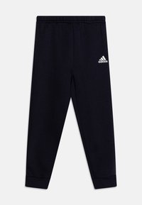Pantalones de chándal azul marino con cintura elástica, puños acanalados y un logo blanco de Adidas en el muslo izquierdo. Fabricados con una tela suave y elástica.