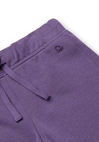 Fioletowe spodnie dresowe z ściągaczem w pasie. Zdobione małym, wyszywanym logo w ciemniejszym odcieniu fioletu. Miękka tkanina o gładkiej fakturze.