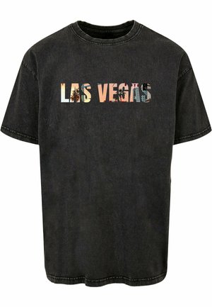 T-shirt nera a maniche corte con una grafica "LAS VEGAS" che presenta un mix di colori e immagini. Realizzata in cotone con una vestibilità comoda.