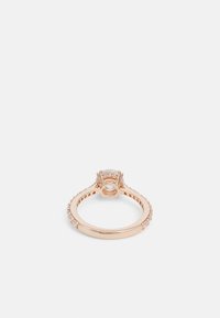 Anello in oro rosa con una pietra centrale tonda circondata da pietre più piccole ai lati, con una fascia liscia e dettagli decorativi.