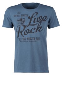 Modrá bavlněná tričko s krátkým rukávem a kulatým výstřihem. Na přední straně je výrazný černý grafický text: "Žij Rock" a "Punk Monster Ball."