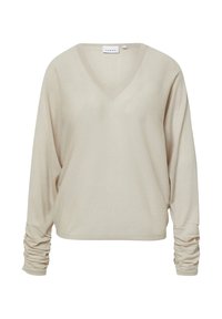 Beżowy sweter z dekoltem w serek, z długimi, marszczonymi rękawami i miękką, teksturowaną tkaniną. Luźny styl odpowiedni do noszenia na cebulkę lub samodzielnie.